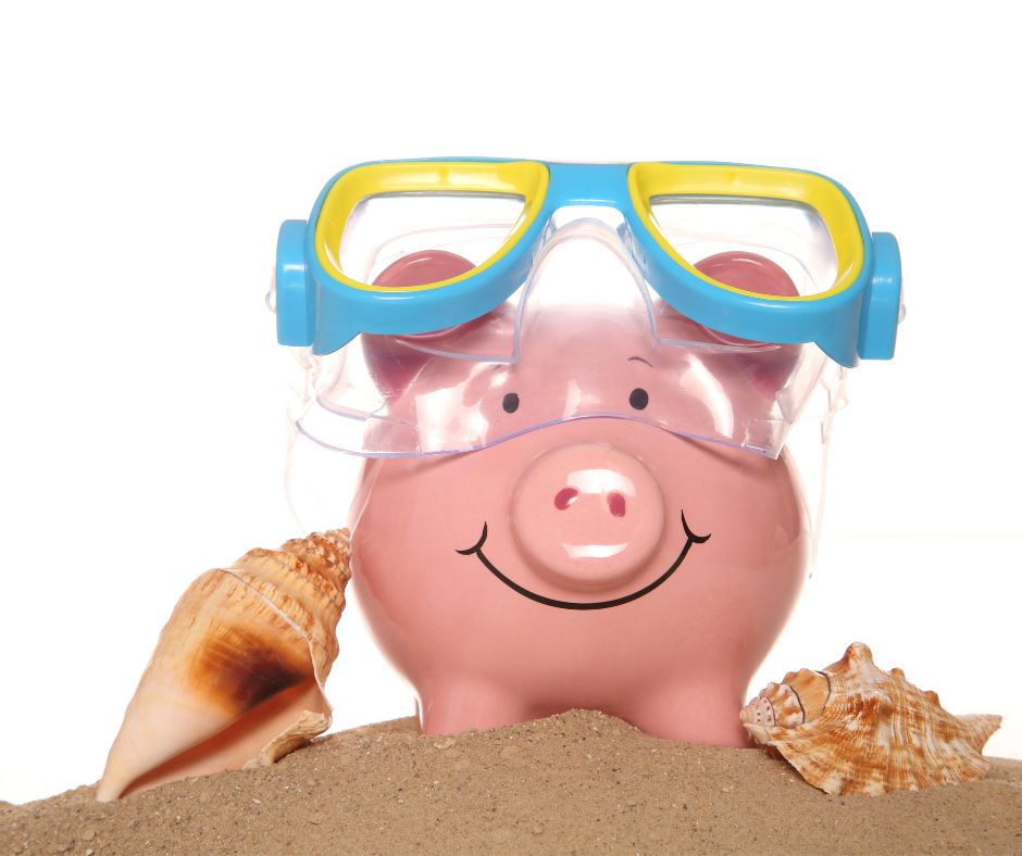 piggy bank with swimming goggles on holiday