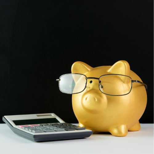 golden piggy bank with glasses on and calculator