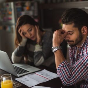 couple worried about money on laptop